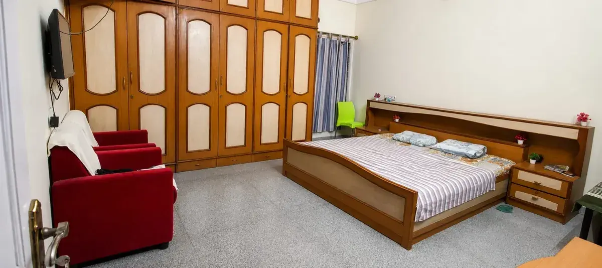 Warm and welcoming caregiver assisting elderly residents at Vishwa Old Age Home